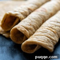 Effortlessly Soft and Pliable Oat Tortillas 11 Three Oat Flour Tortillas rolled next to each other.