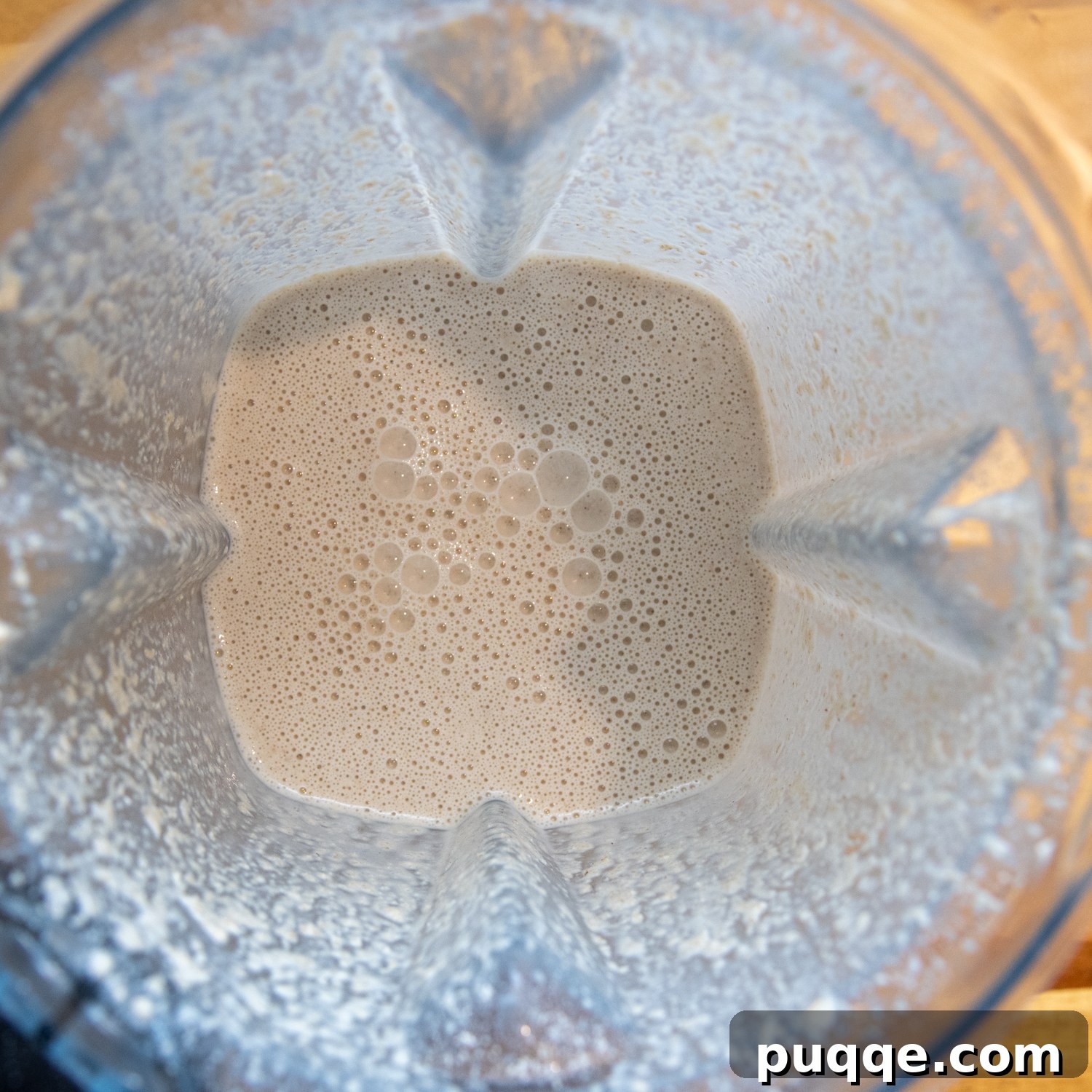 Effortlessly Soft and Pliable Oat Tortillas 4 Wet tortilla ingredients, including water, oil, and salt, added to the oat flour in a blender.