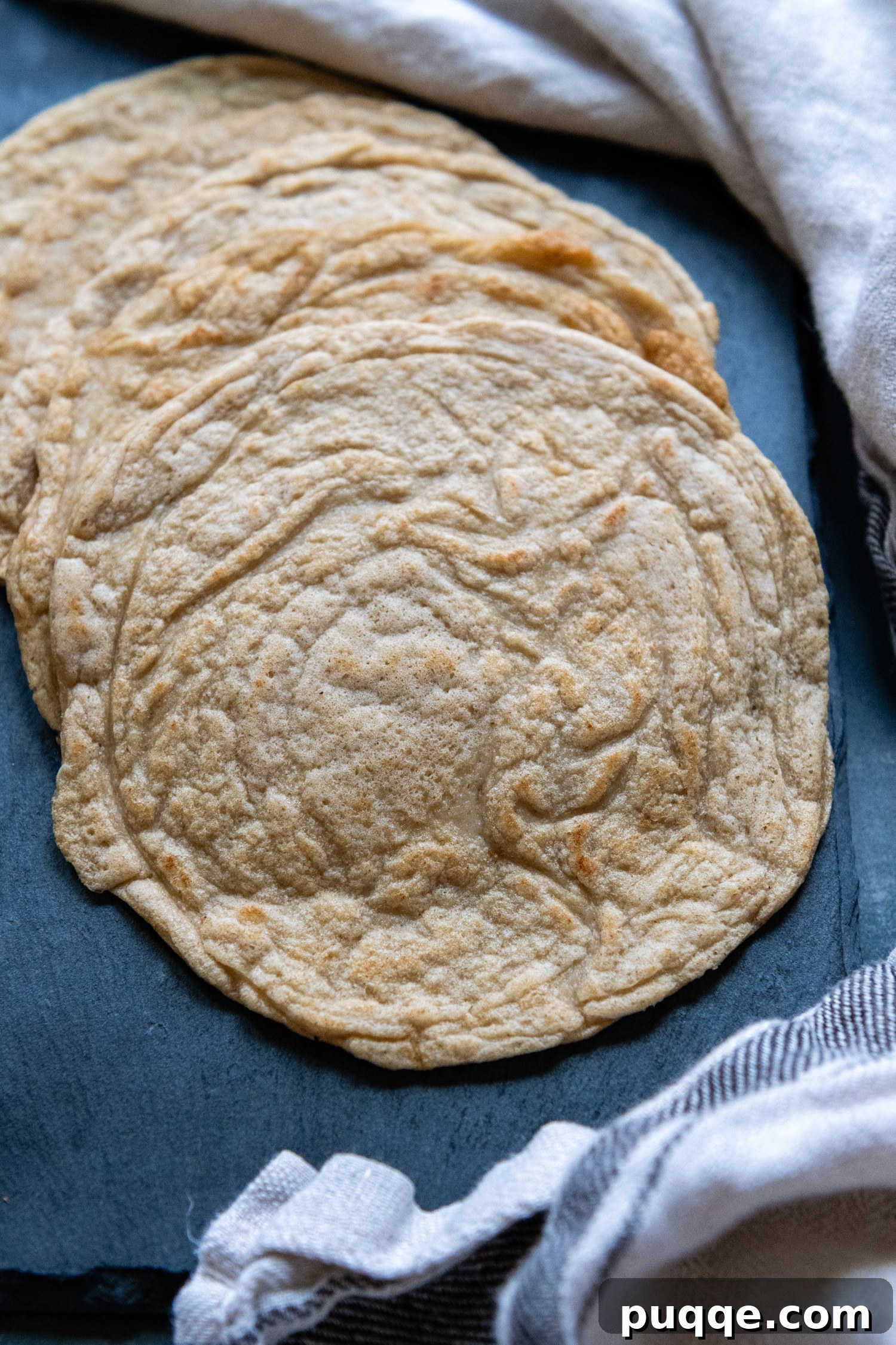 Effortlessly Soft and Pliable Oat Tortillas 9 A stack of freshly cooked oat tortillas, showcasing their softness and even cooking.