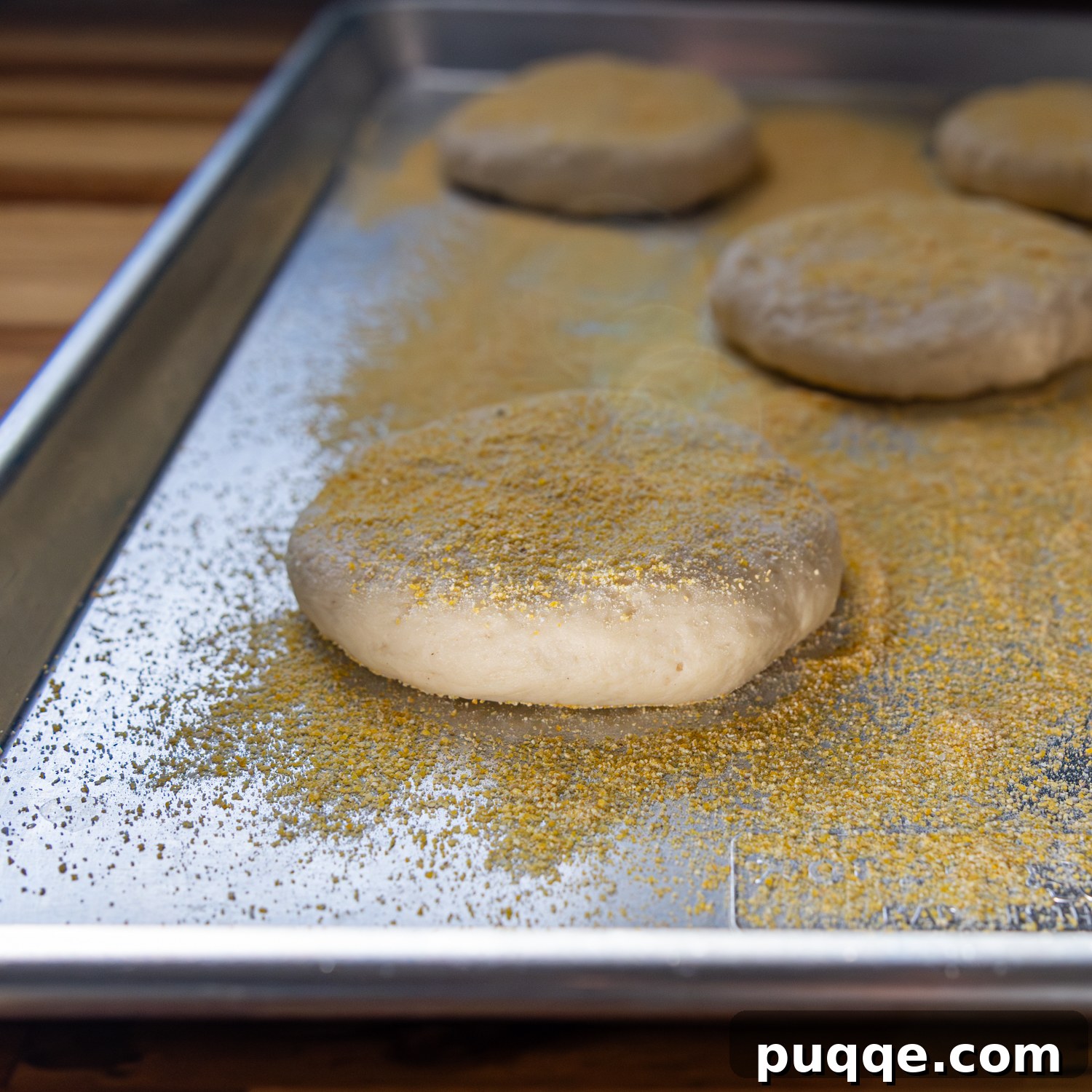 Dough balls flattened and spaced evenly on a baking sheet.