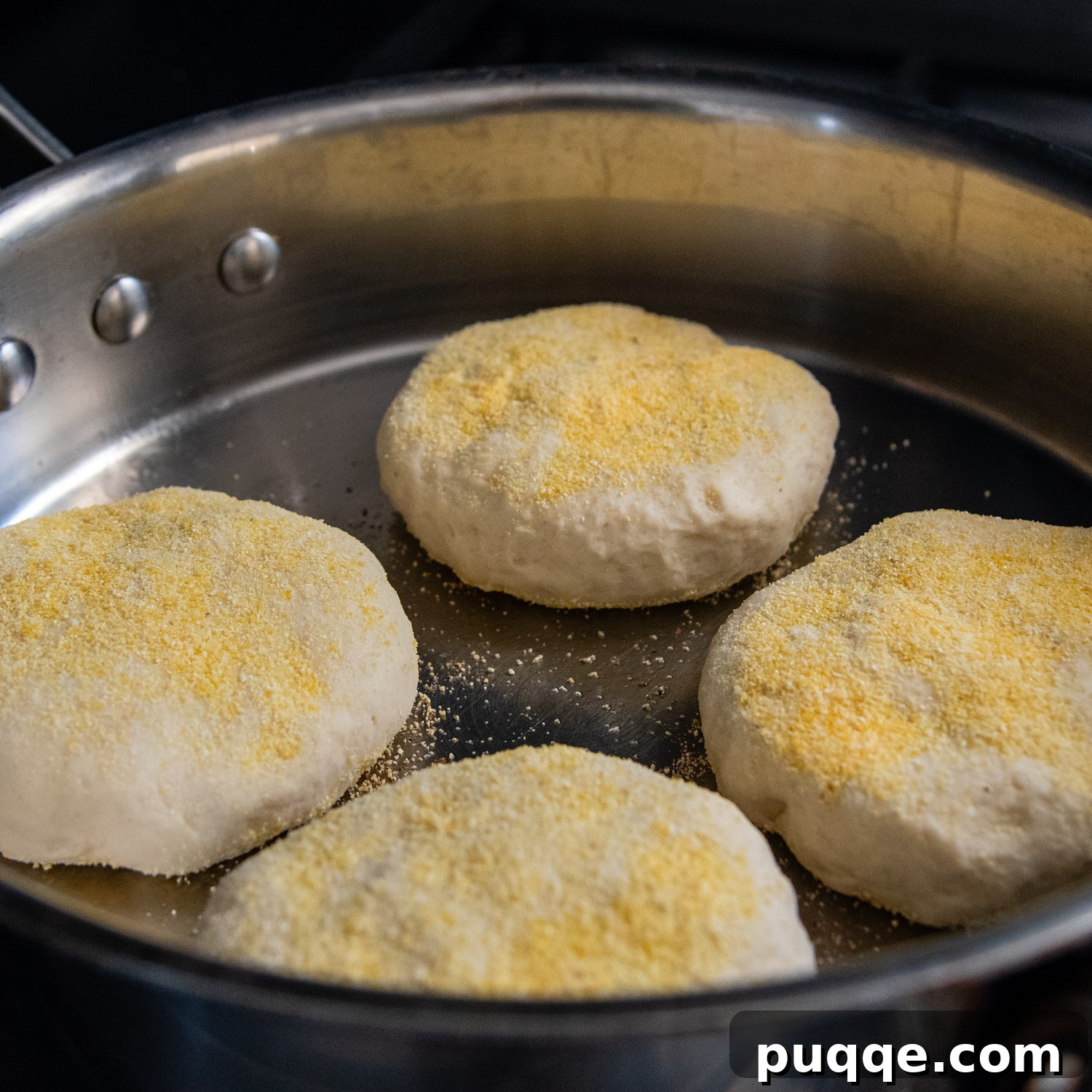 Muffins frying in a pan.