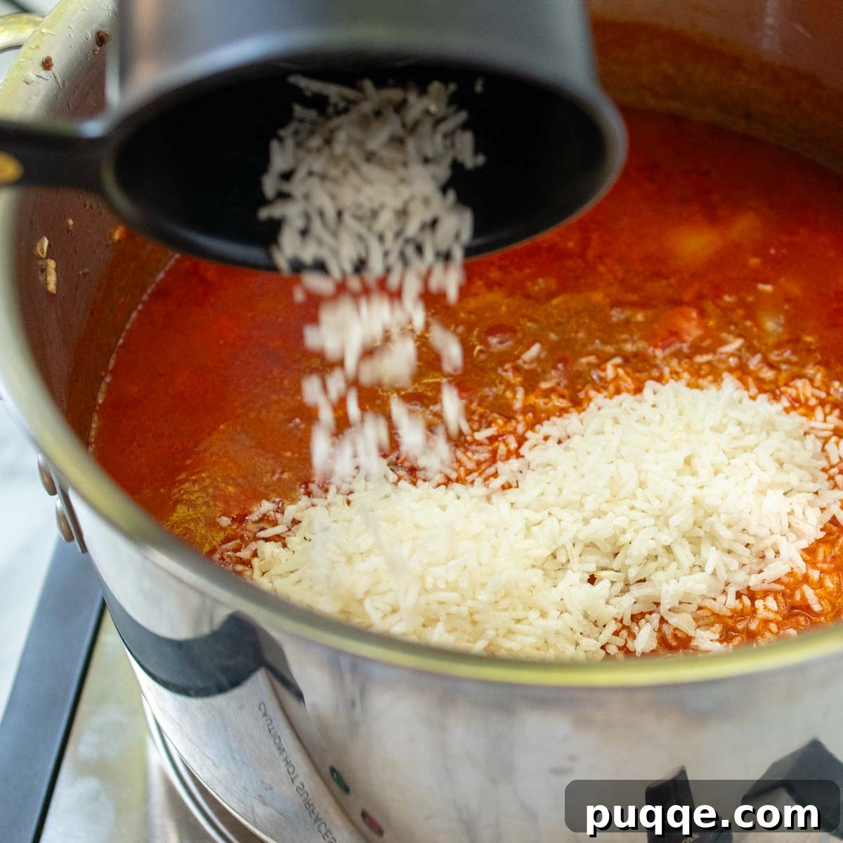 The Perfect Stuffed Pepper Soup 6 Instant rice being stirred into the stuffed pepper soup.