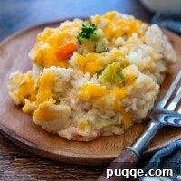 A serving of Gluten-Free Chicken Rice Casserole on a plate with a fork.
