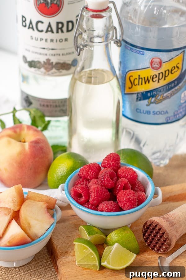 Ultimate Raspberry Peach Mojito 4 all the makings laid out to make a raspberry peach mojito