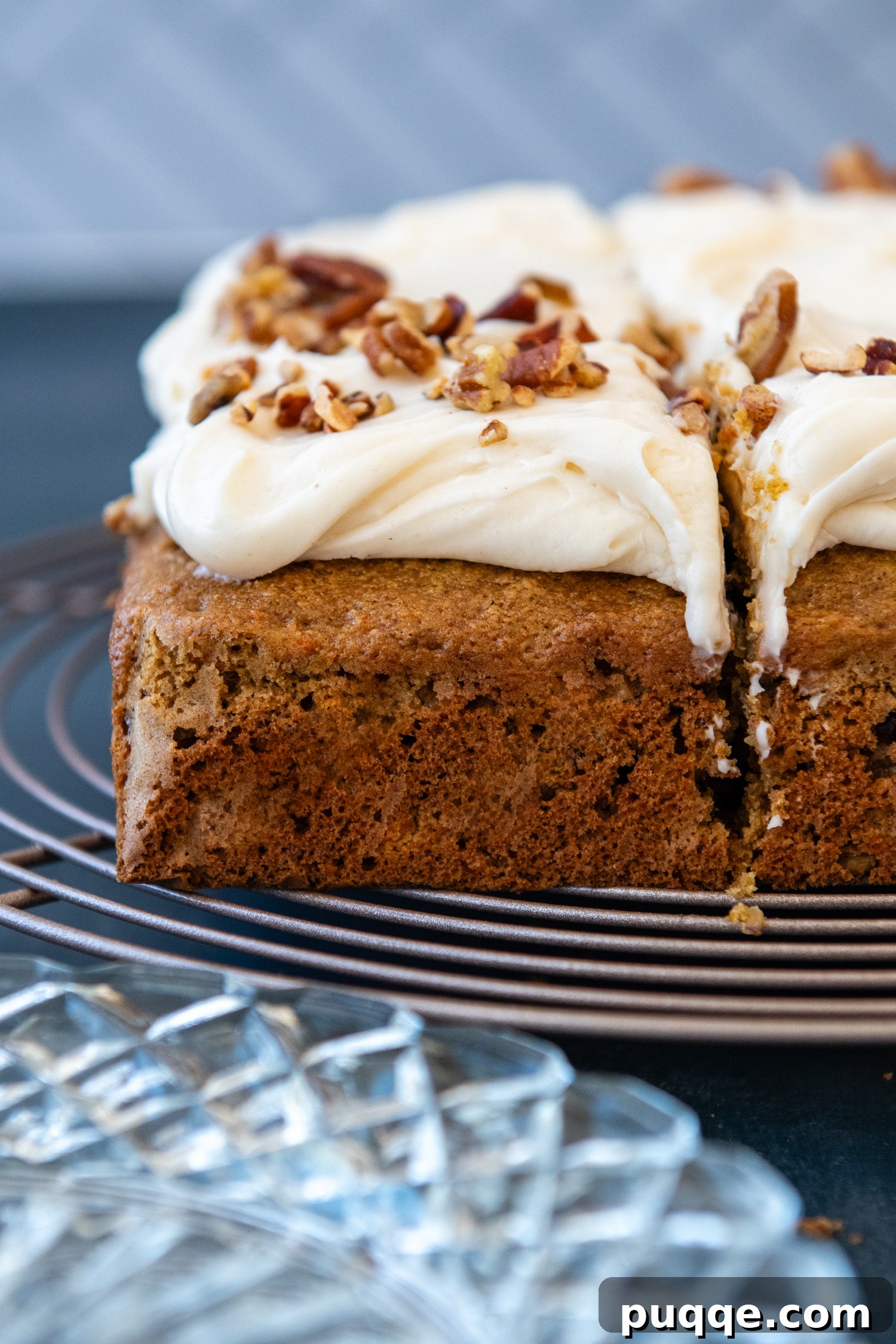 Heavenly Oat Flour Carrot Cake Unbelievably Moist and Light 8 Carrot cake topped with frosting sitting on a wire grate.