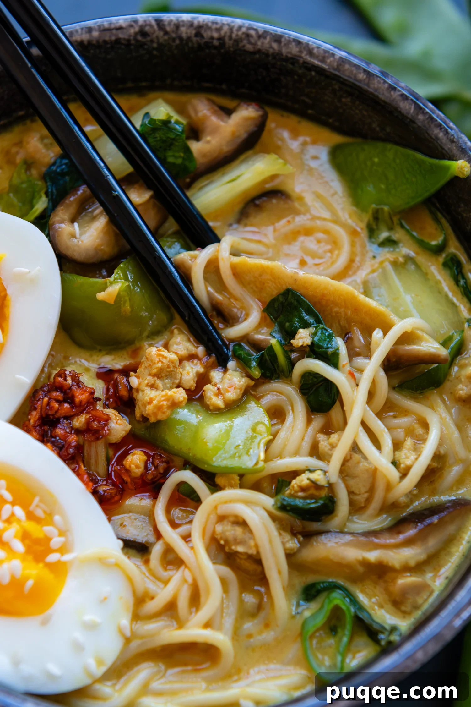 Quick & Creamy Gluten-Free Coconut Ramen Bliss 2 Chopsticks in a bowl with gluten-free ramen and assorted toppings.
