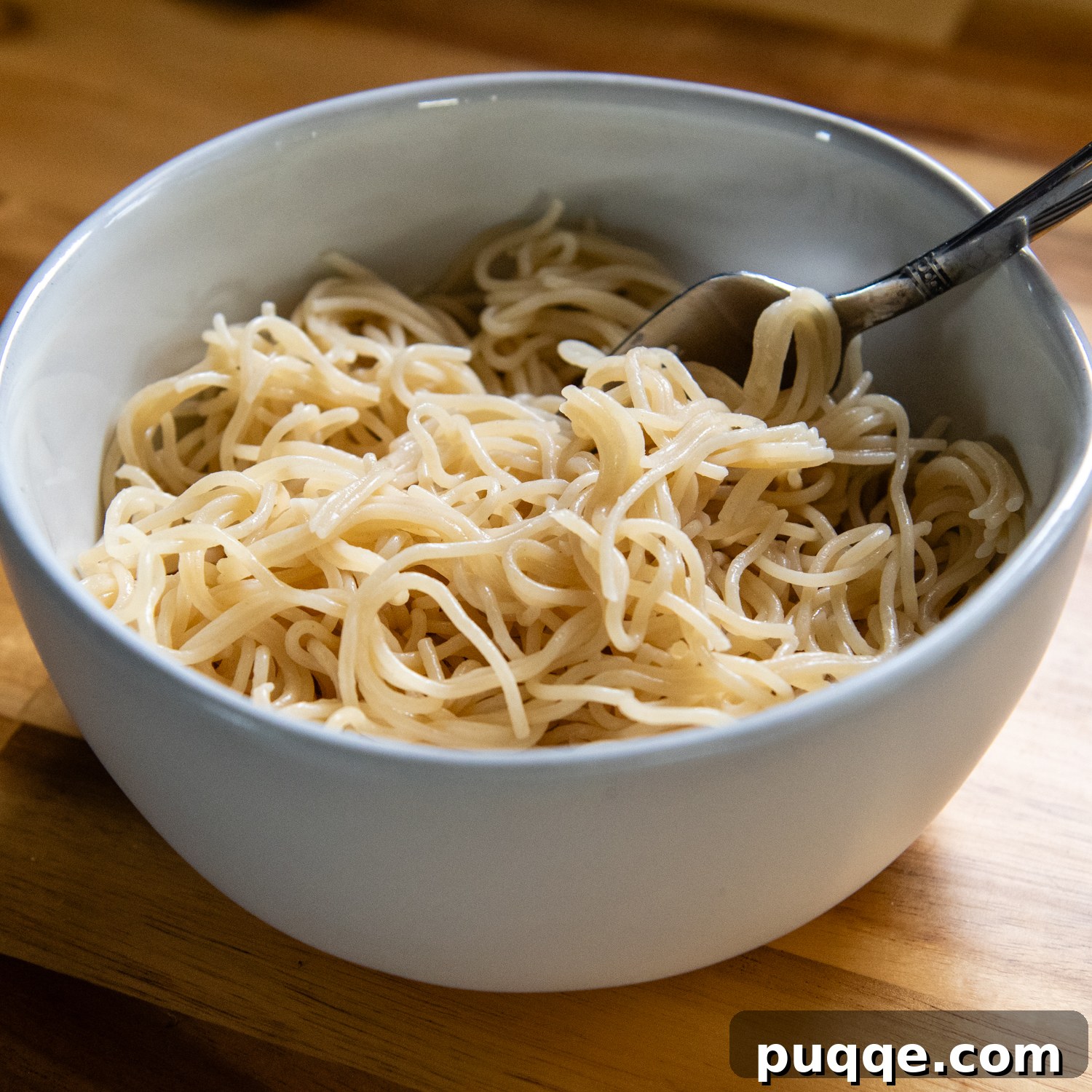 Quick & Creamy Gluten-Free Coconut Ramen Bliss 3 White bowl of ramen noodles with a spoon.