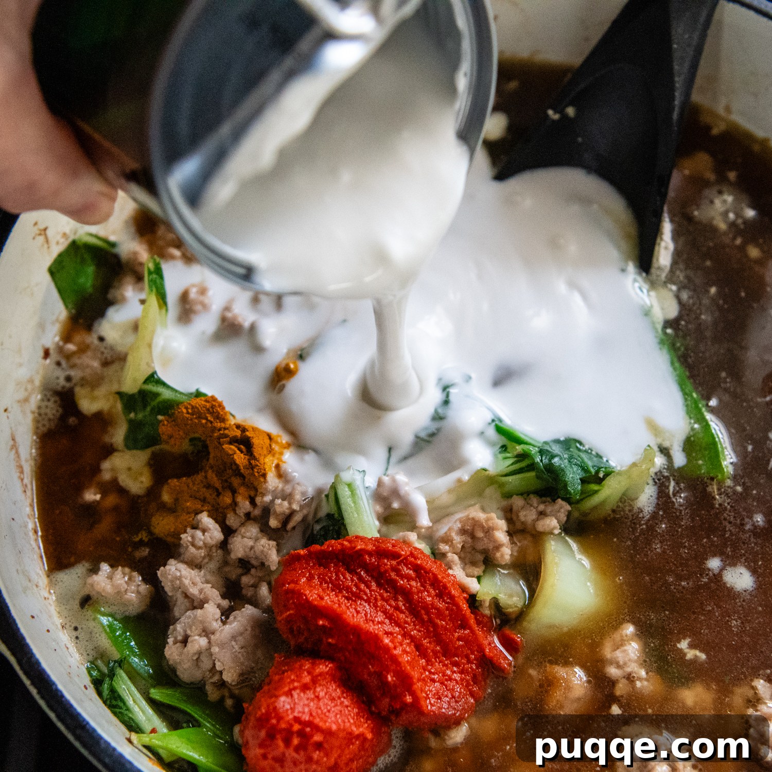 Quick & Creamy Gluten-Free Coconut Ramen Bliss 7 Coconut milk being poured into ramen.