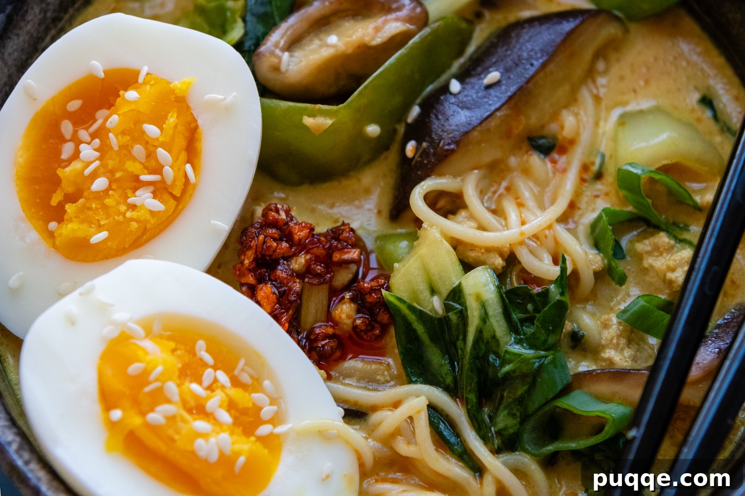 Quick & Creamy Gluten-Free Coconut Ramen Bliss 8 Close up of ramen that includes whole eggs, chili seasonings, and greens.