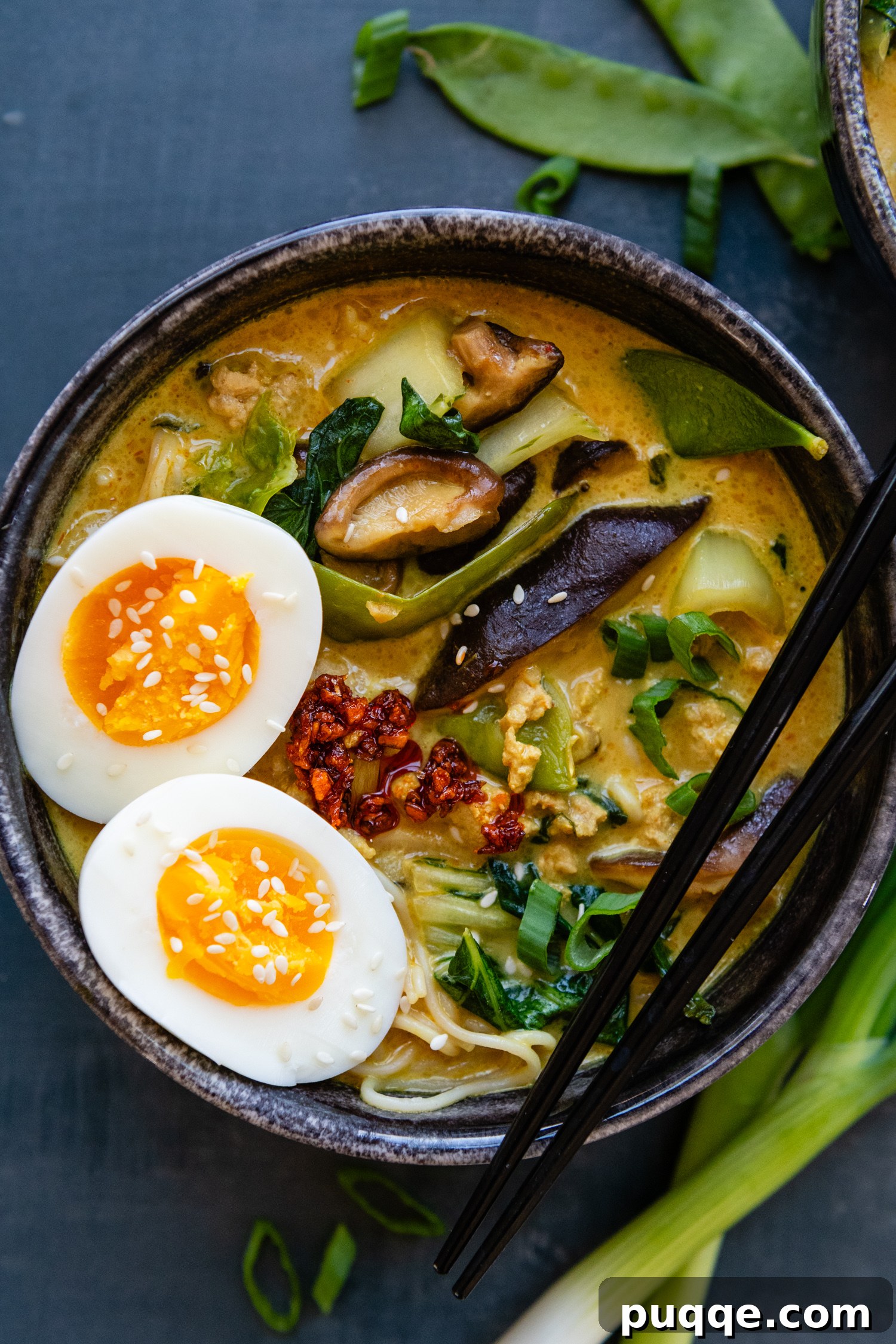 Quick & Creamy Gluten-Free Coconut Ramen Bliss 9 Bowl of ramen with whole eggs and seasonings with chopsticks.