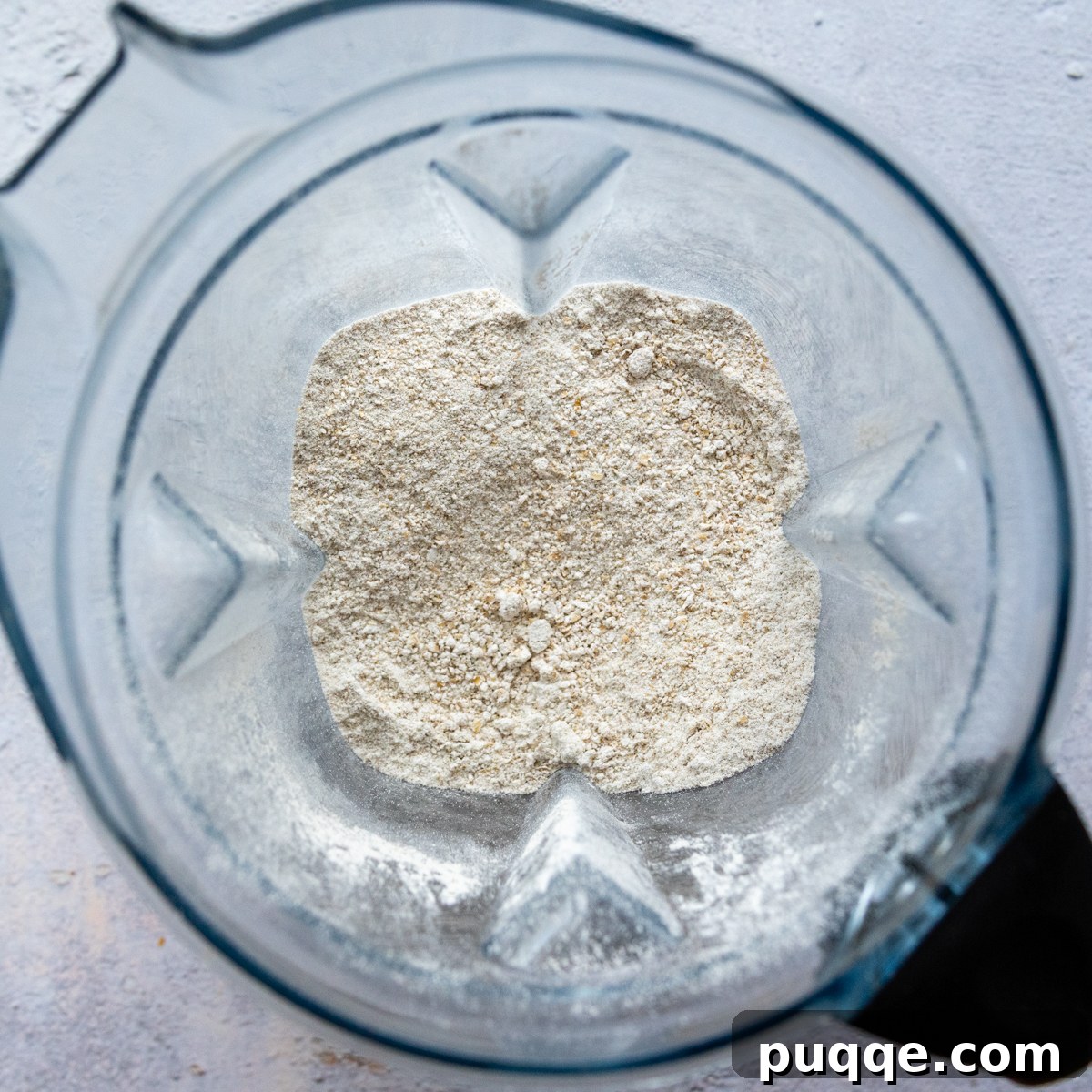 Dry ingredients in a blender, showing rolled oats being ground into flour.