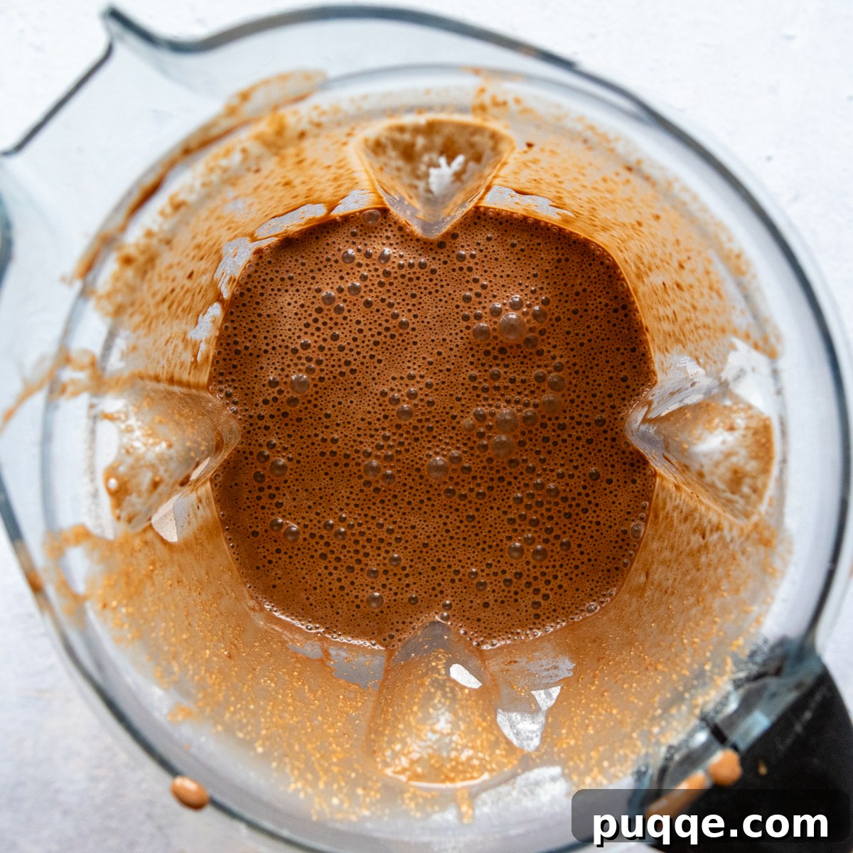 All cake ingredients in a blender, ready for a final blend.