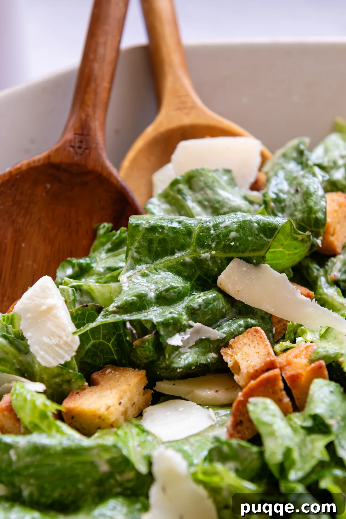 A vibrant bowl of Caesar salad, impeccably dressed and garnished.