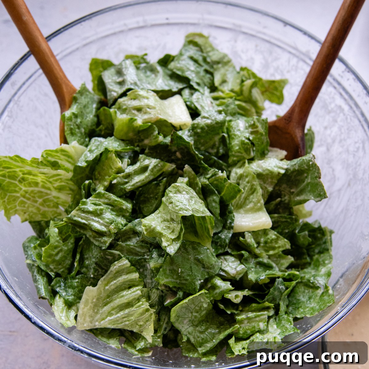 Fresh hearts of romaine, ready for tossing in a glass bowl.