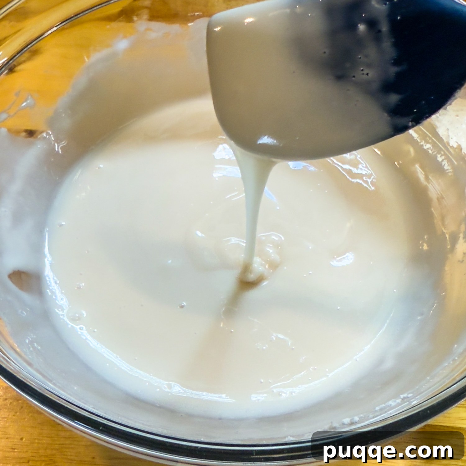 No-Fuss Gluten-Free Apple Fritters 9 Glaze dripping from a spoon.