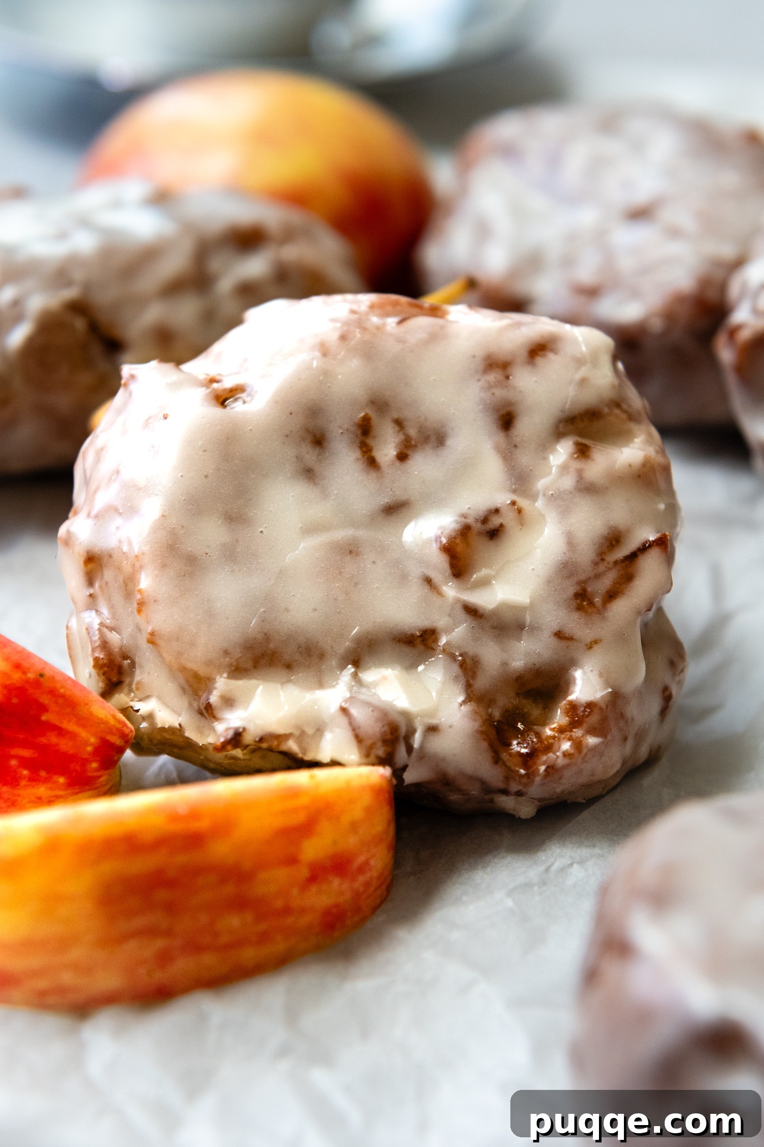 No-Fuss Gluten-Free Apple Fritters 10 Apple fritter close up with a slice of apple.