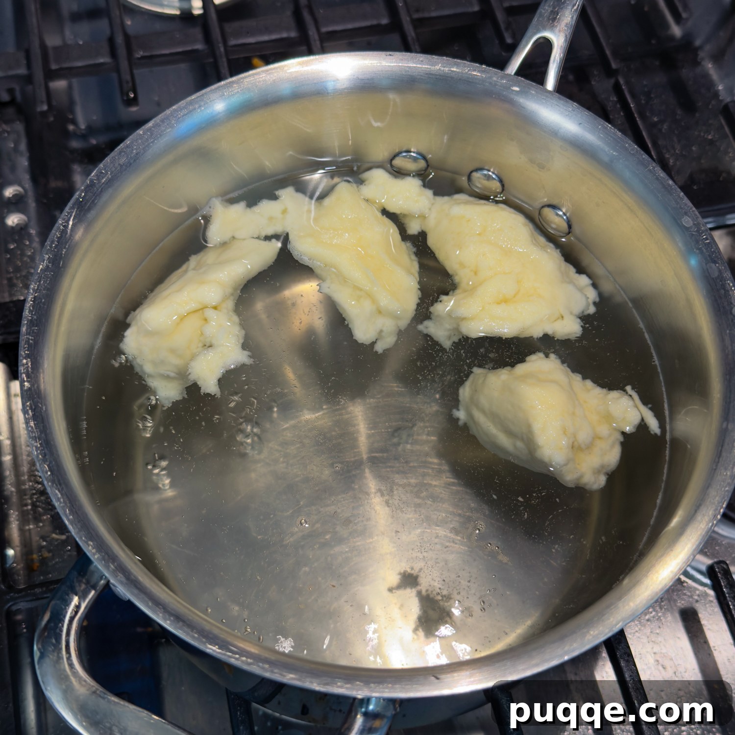 Hearty Gluten-Free German Dumplings and Sausage 6 Gluten-free dumplings gently cooking in boiling water, beginning to float.