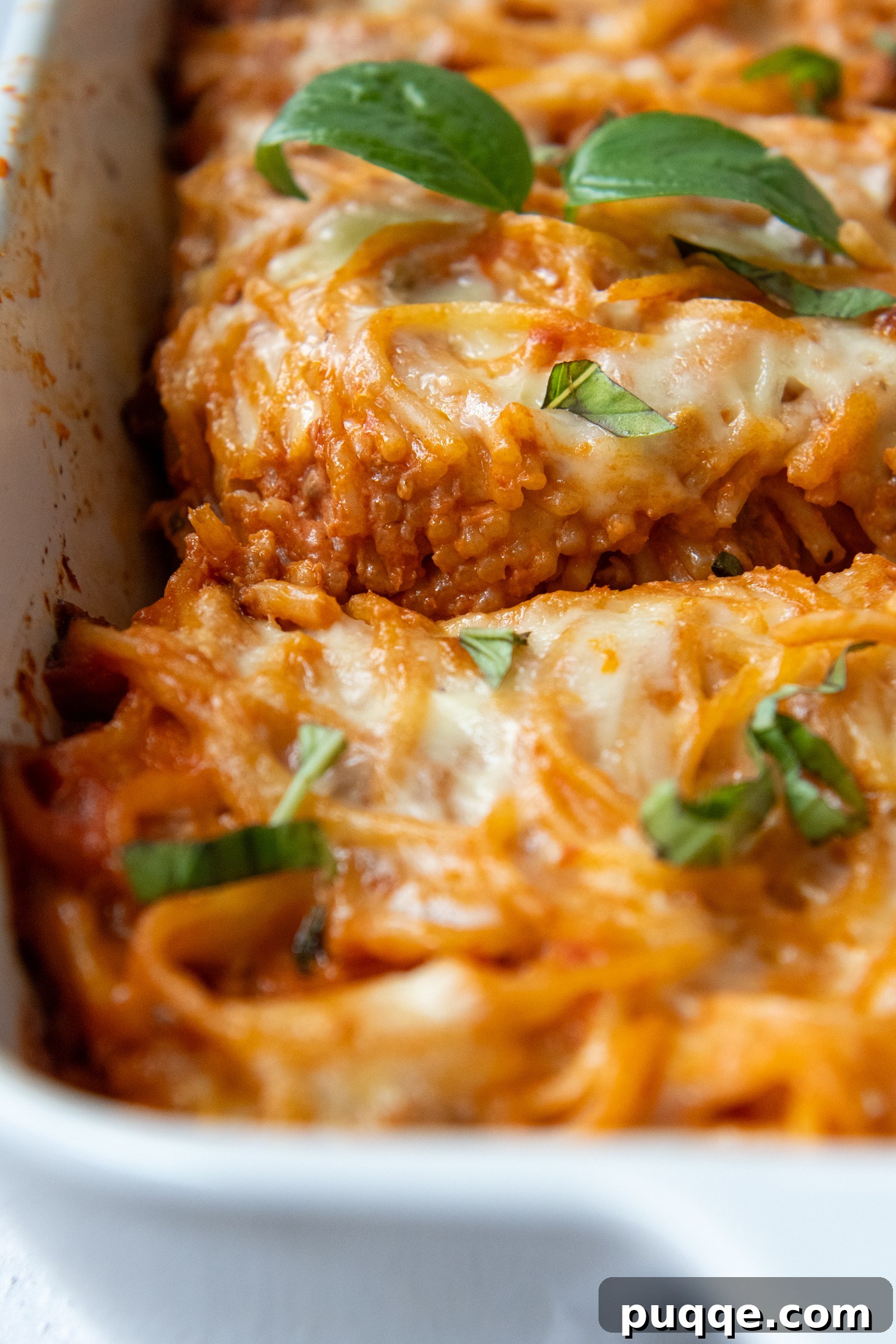 Scrumptious Gluten-Free Spaghetti Bake 9 Casserole cooked and cut in a white baking dish.