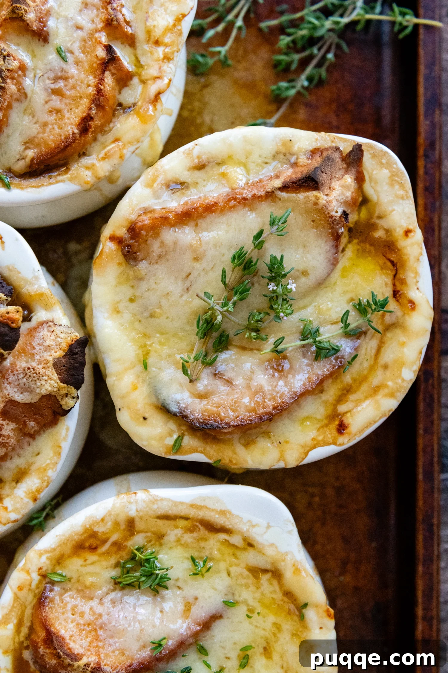Easy Gourmet Gluten-Free French Onion Soup 2 Overhead shot of Gluten-Free French Onion Soup in a white soup crock topped with fresh parsley, ready to be served.