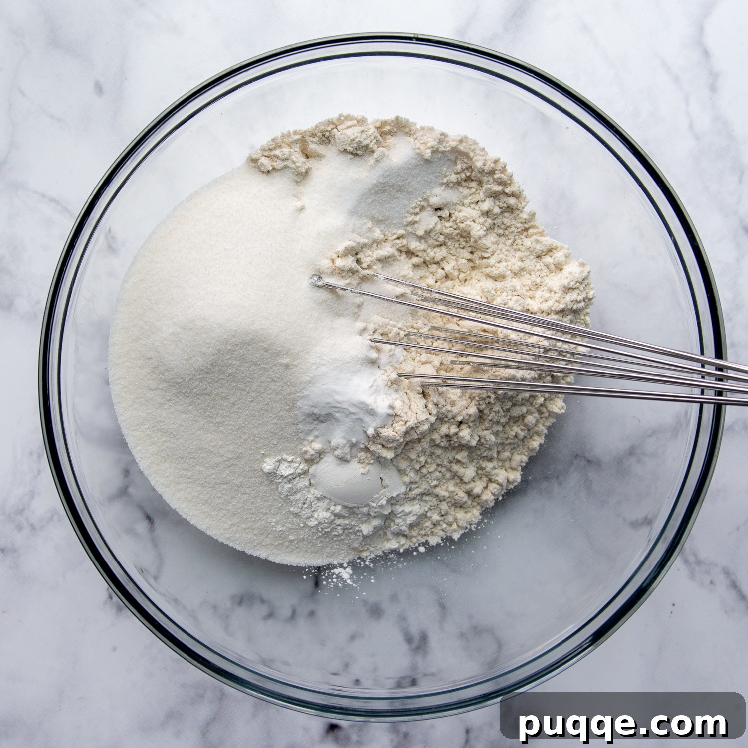 Fluffy Gluten-Free Funfetti Birthday Delight 3 Dry ingredients being mixed in a glass bowl, showcasing the foundation for a fluffy gluten-free cake.