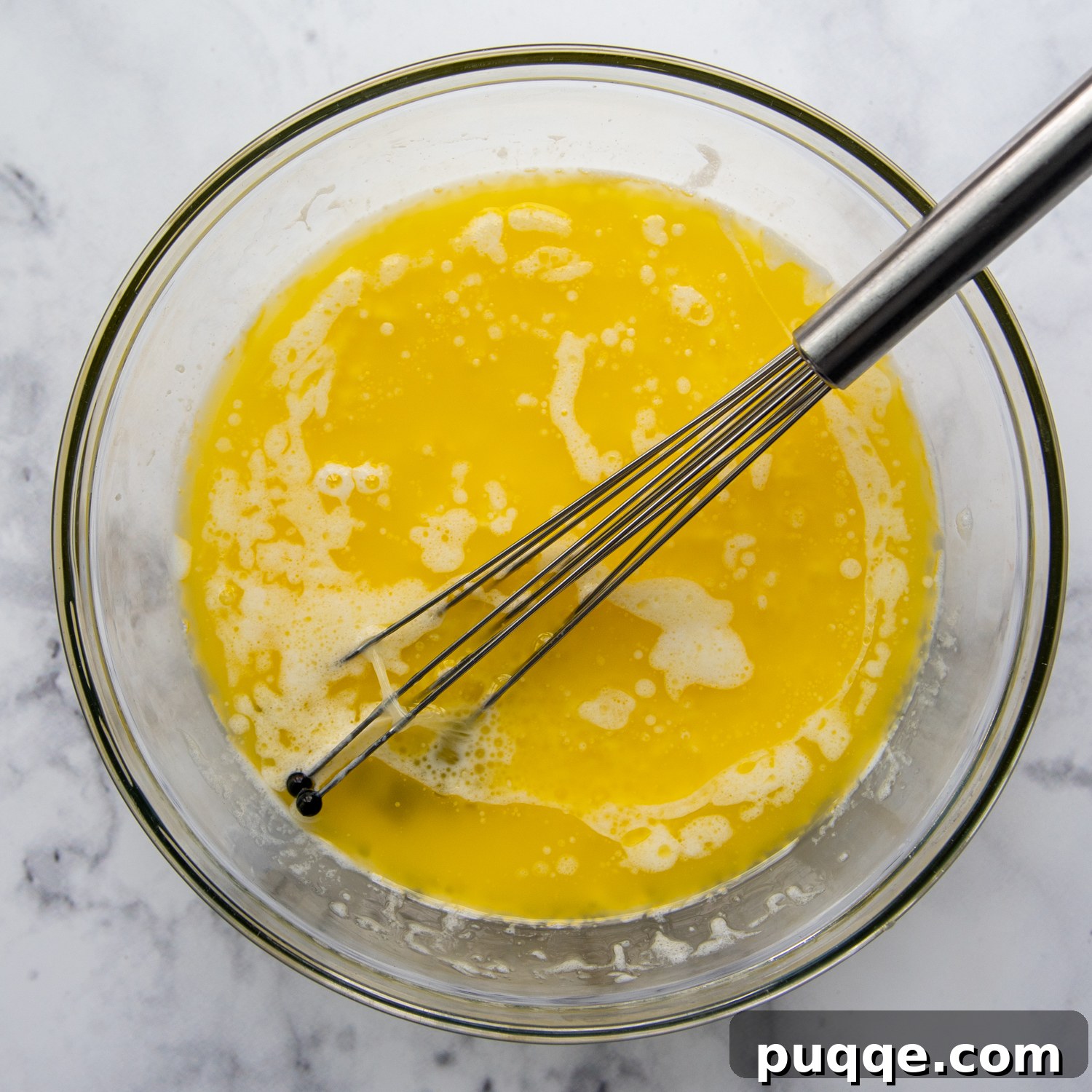 Fluffy Gluten-Free Funfetti Birthday Delight 4 A glass bowl of perfectly cooled melted butter, a key ingredient for moist gluten-free baking.
