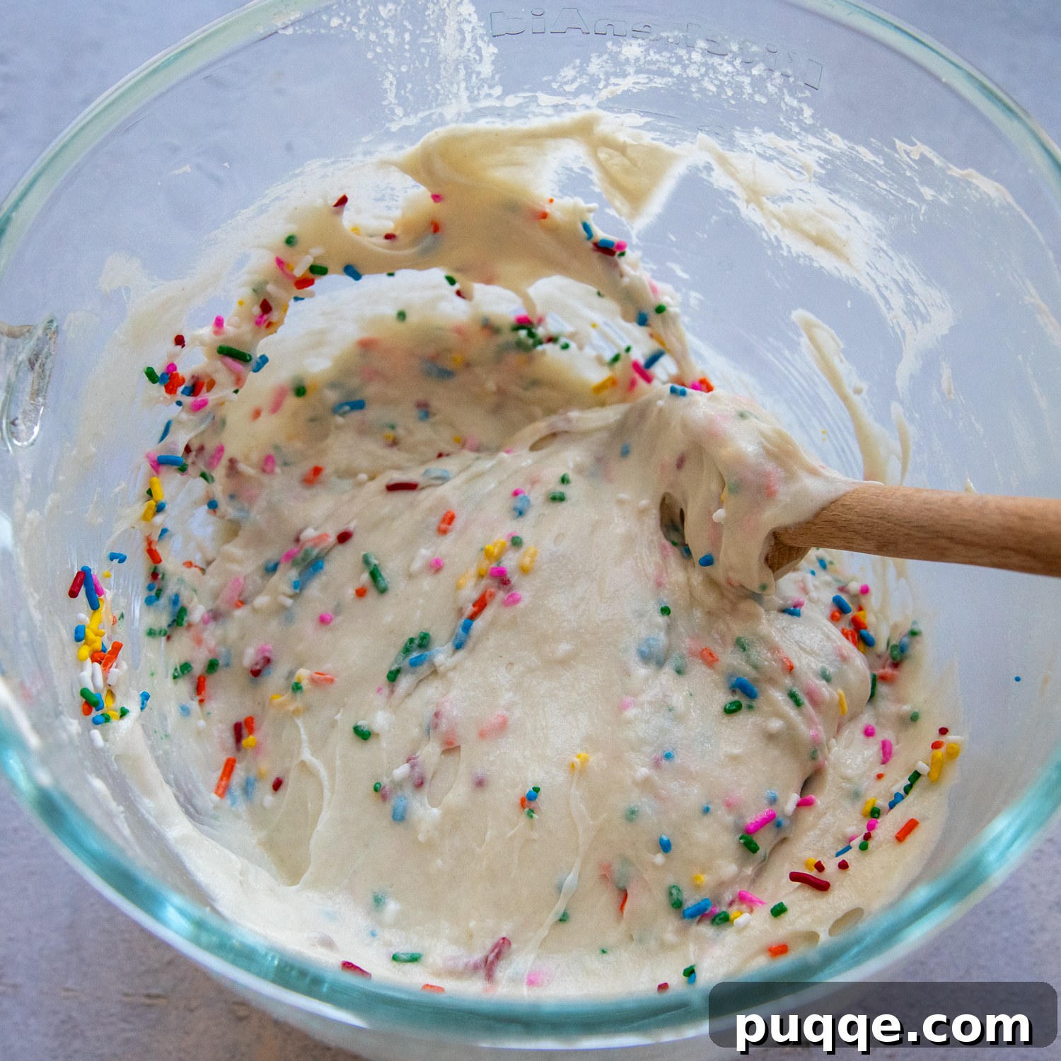 Fluffy Gluten-Free Funfetti Birthday Delight 6 Ingredients with vibrant rainbow sprinkles folded in, creating the signature funfetti look in a glass bowl.