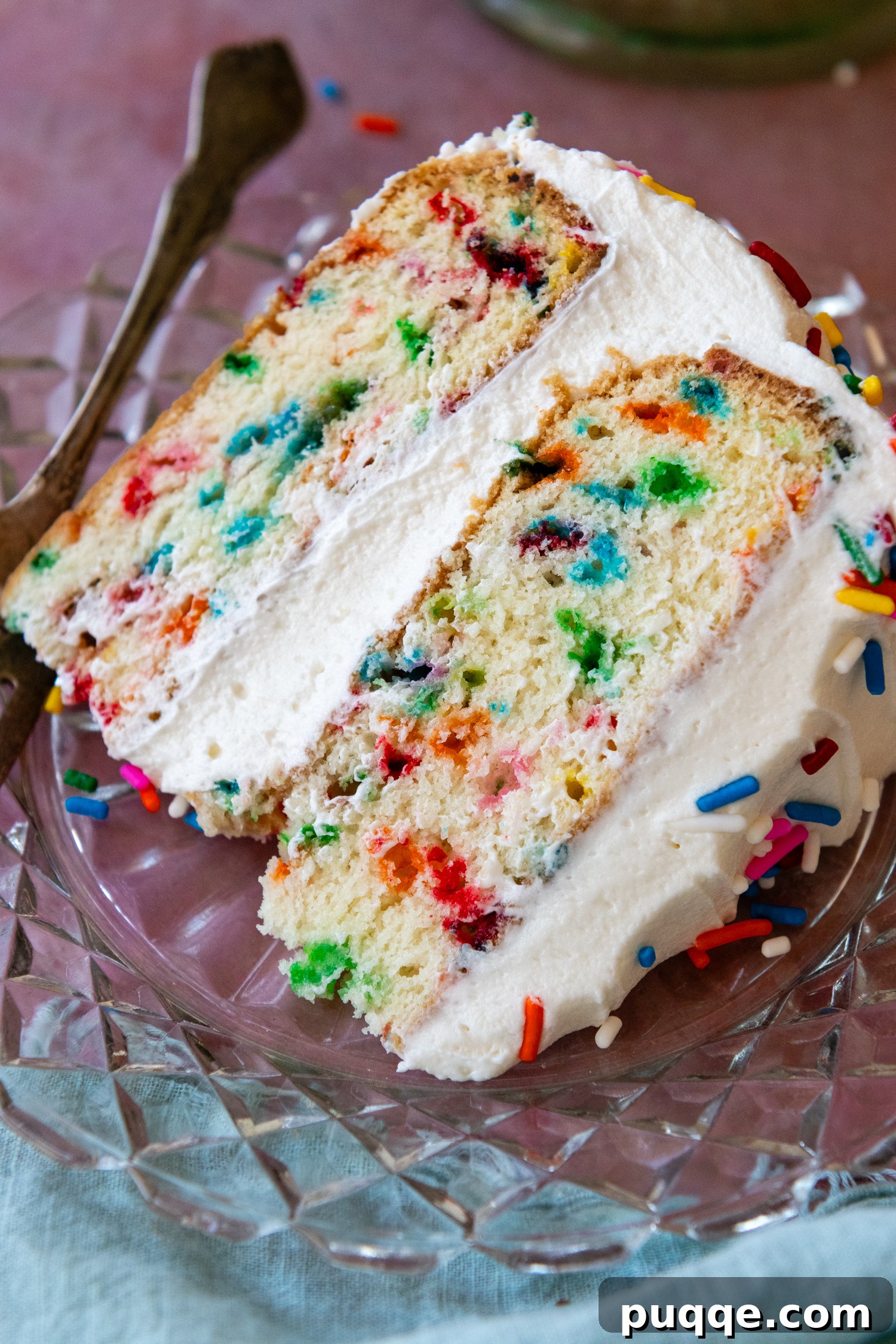 Fluffy Gluten-Free Funfetti Birthday Delight 9 Overhead shot of a perfect slice of gluten-free funfetti cake on a glass plate, showcasing its moist layers and colorful sprinkles.