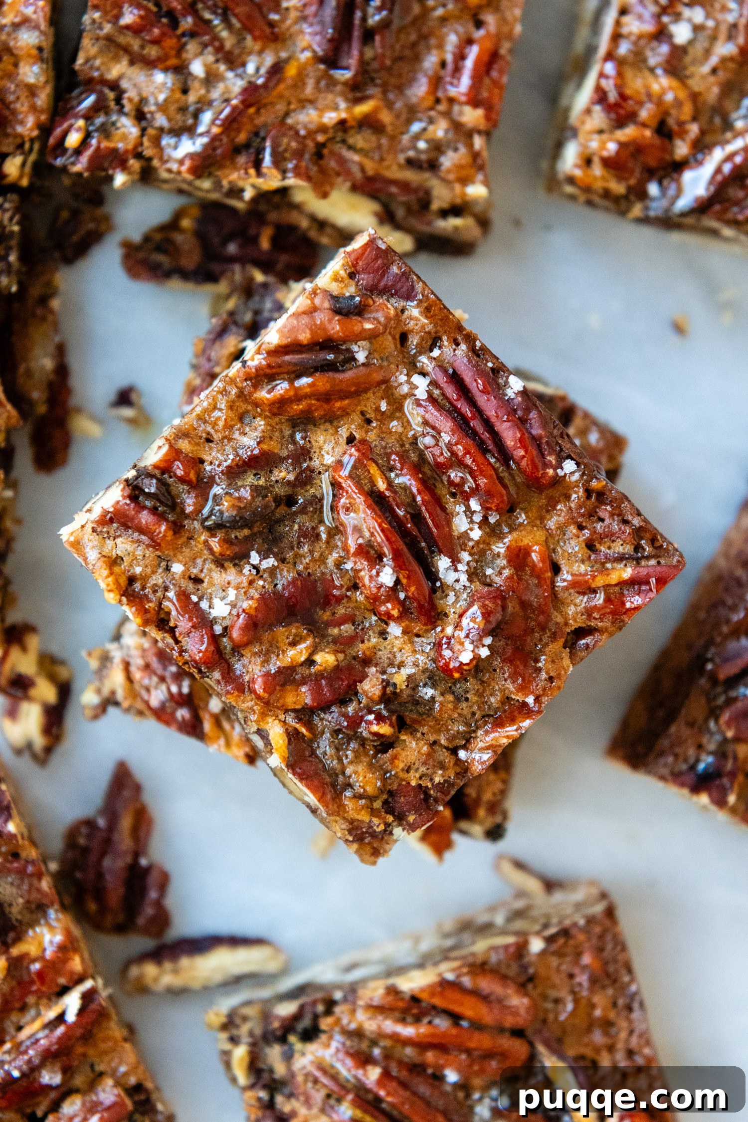 Overhead shot of Gluten-Free Pecan Pie Bars, highlighting the intricate detail of the pecan topping and golden crust.