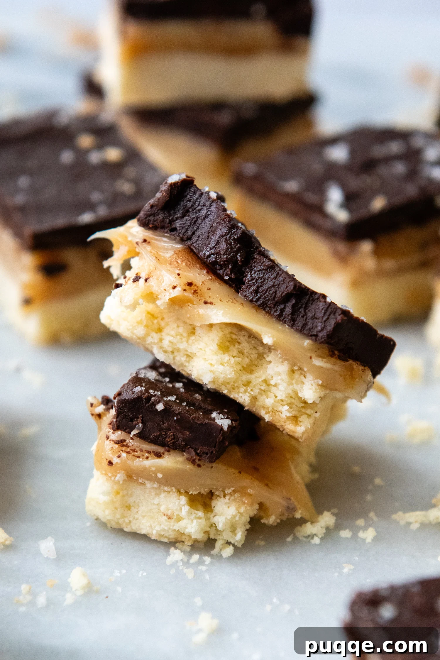 Effortless Gluten-Free Millionaire Bars 2 Stack of gluten free millionaire bars, showcasing the three distinct layers: shortbread, caramel, and chocolate, topped with flaky sea salt.