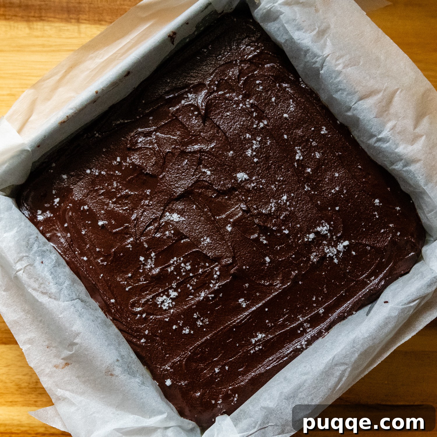 Effortless Gluten-Free Millionaire Bars 8 Chocolate layer on top of bars in a pan, sprinkled with flaky sea salt.
