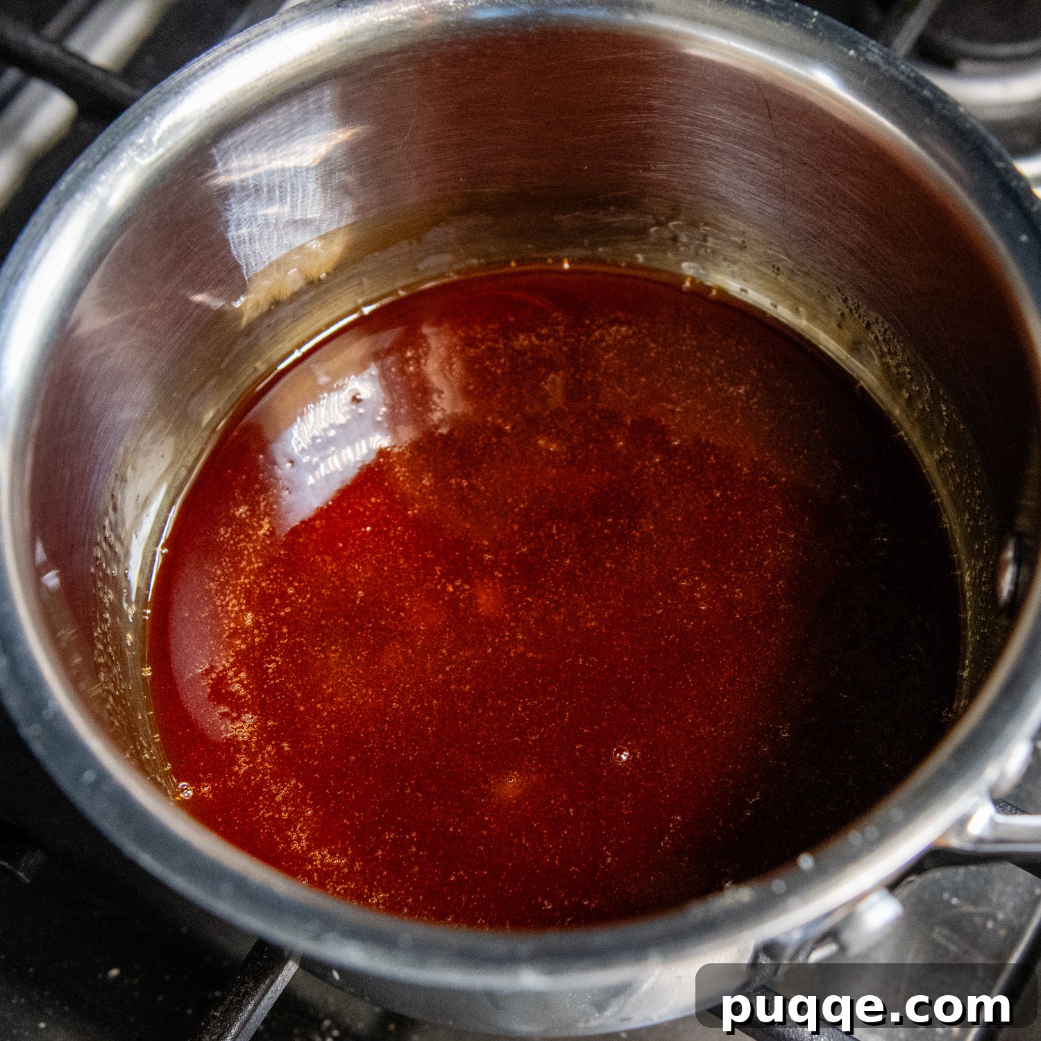 Double Coconut Flan Delight 4 Melted, dark amber caramel in a saucepan, ready to be poured.