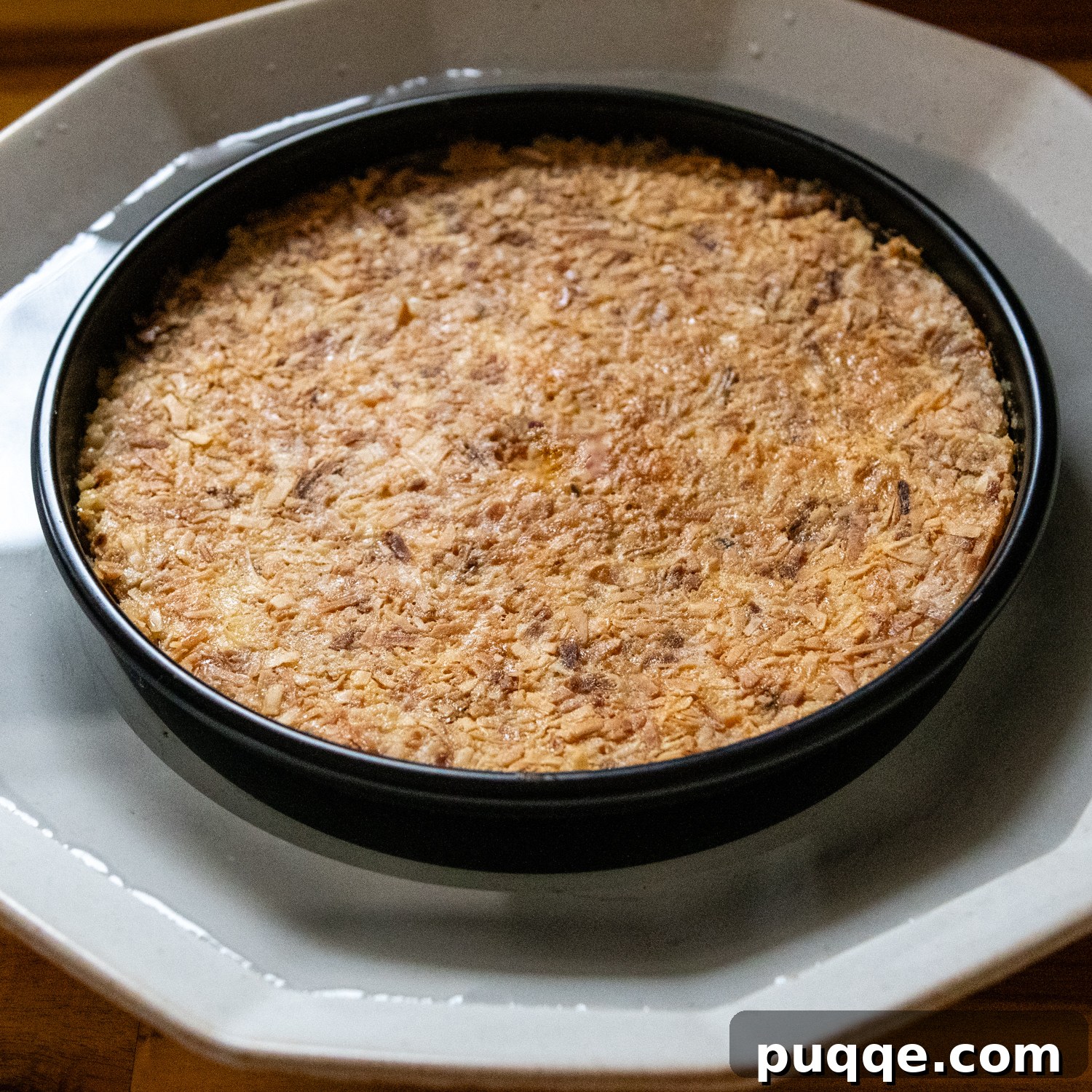 Double Coconut Flan Delight 8 Flan pan placed in a larger pan filled with warm water to loosen the caramel before inversion.