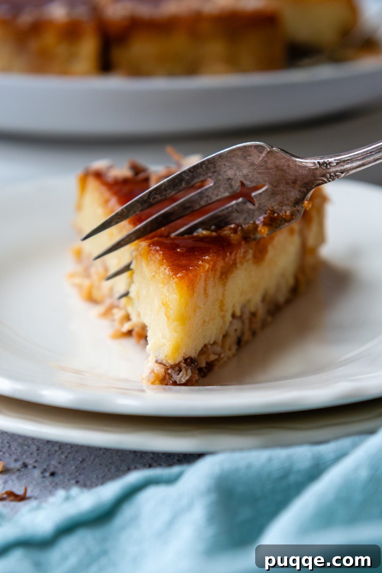 Double Coconut Flan Delight 10 A fork gently cutting into a slice of coconut flan, revealing its soft texture and perfectly set layers.