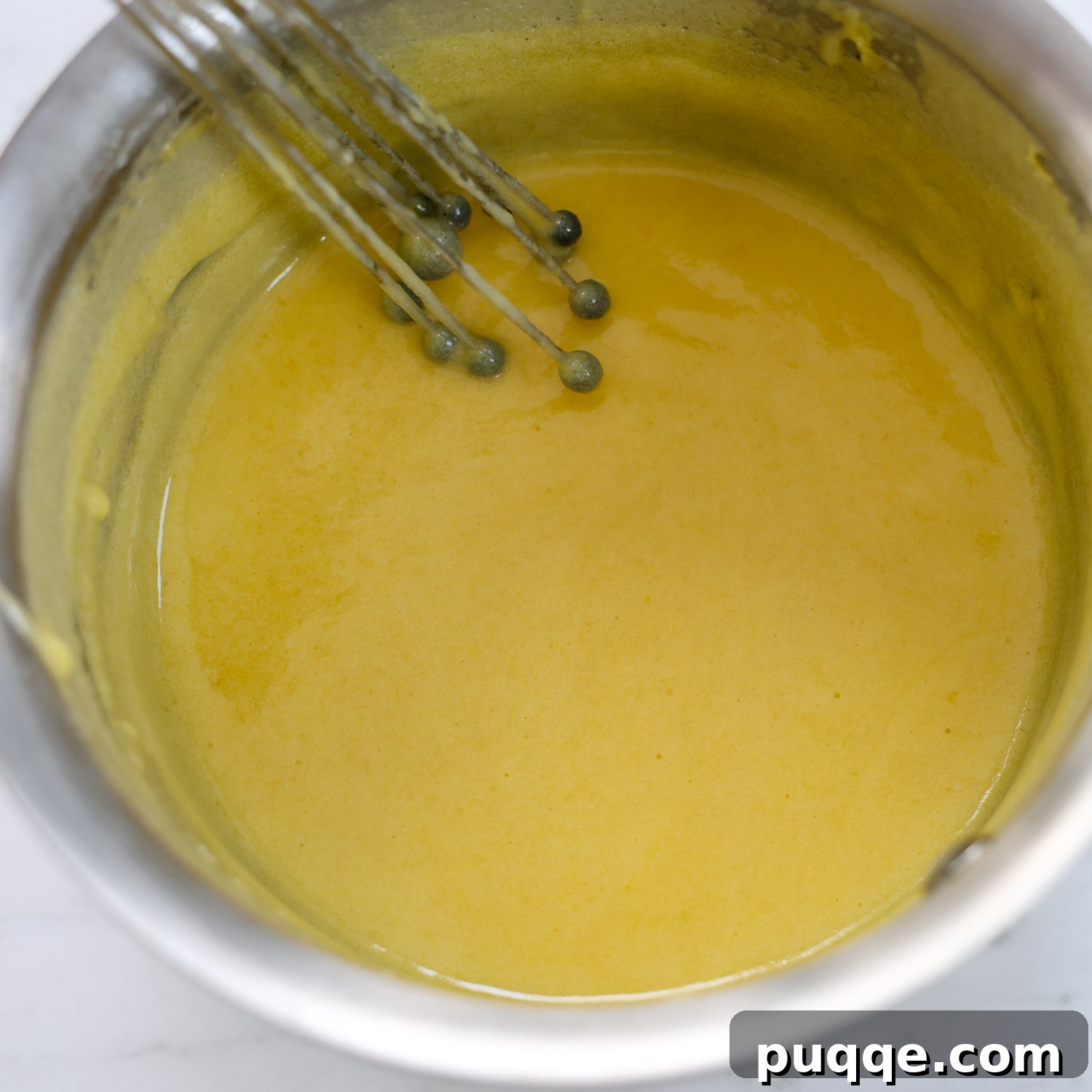Unforgettable Gluten-Free Tiramisu Made Easy 3 Whisking egg yolks, sugar, and milk in a saucepan to create the custard base for tiramisu.