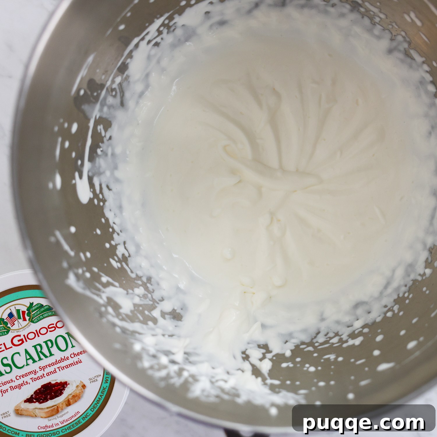 Unforgettable Gluten-Free Tiramisu Made Easy 4 Heavy cream and mascarpone cheese being mixed together in a bowl to create a fluffy texture.
