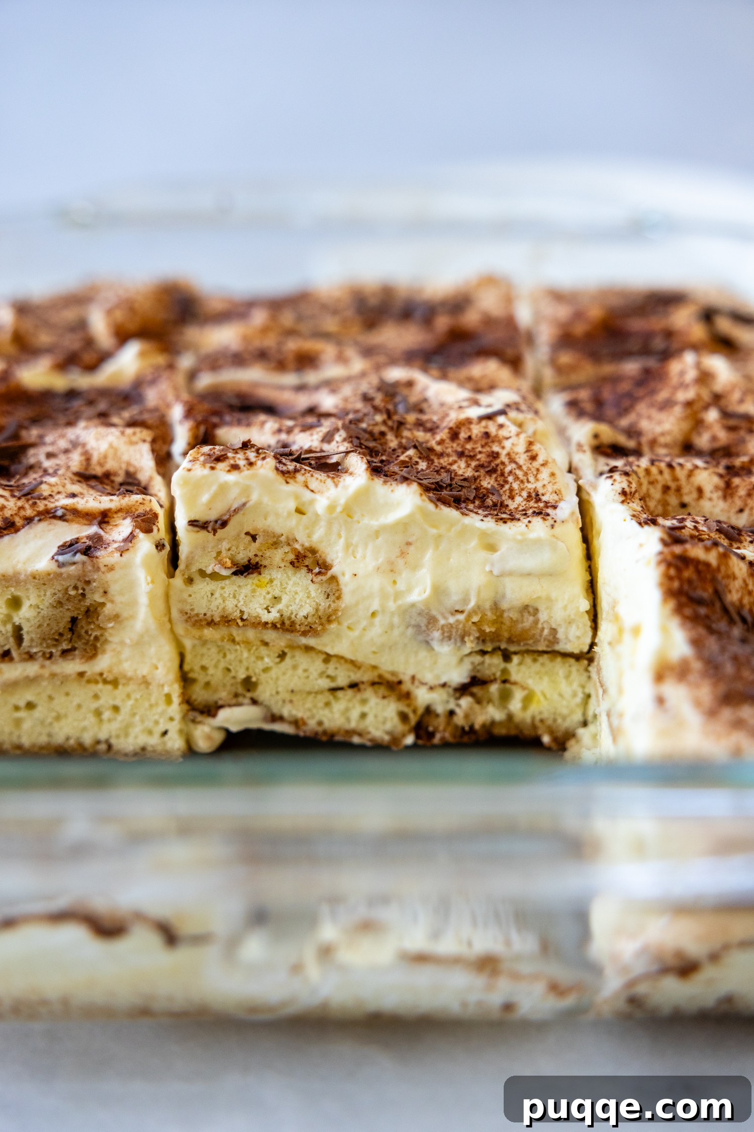 Unforgettable Gluten-Free Tiramisu Made Easy 7 A beautifully set gluten-free tiramisu in a glass baking dish, ready to be served.