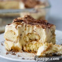 A slice of tiramisu with a bite taken out of it.