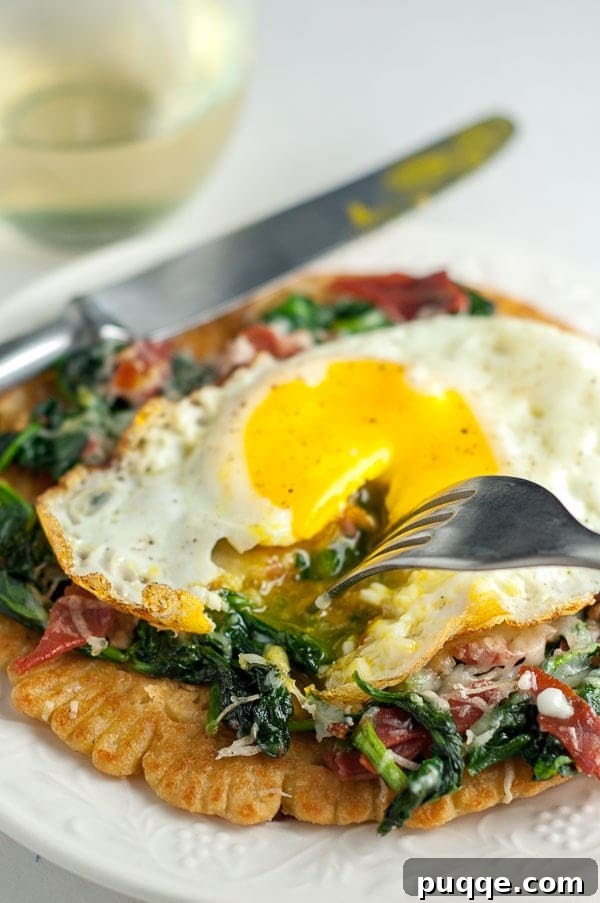 Savory Prosciutto, Spinach and Egg Farinata 3 a fork cutting into a running egg on socca pizza