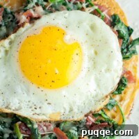 Savory Prosciutto, Spinach and Egg Farinata 5 overhead shot of spinach, egg, prosciutto socca pizza on a white plate