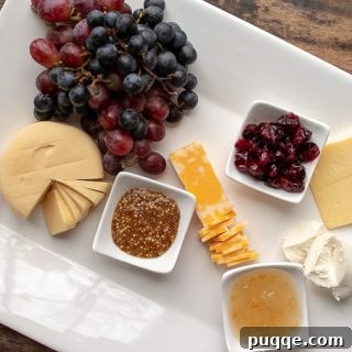 second step of how to make a charcuterie board - adding cheeses