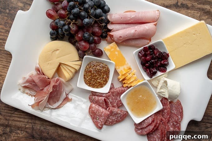 Creative Charcuterie Boards 6 Third step in charcuterie board preparation: artfully arranging a selection of cured meats in various shapes and forms to enhance visual appeal.
