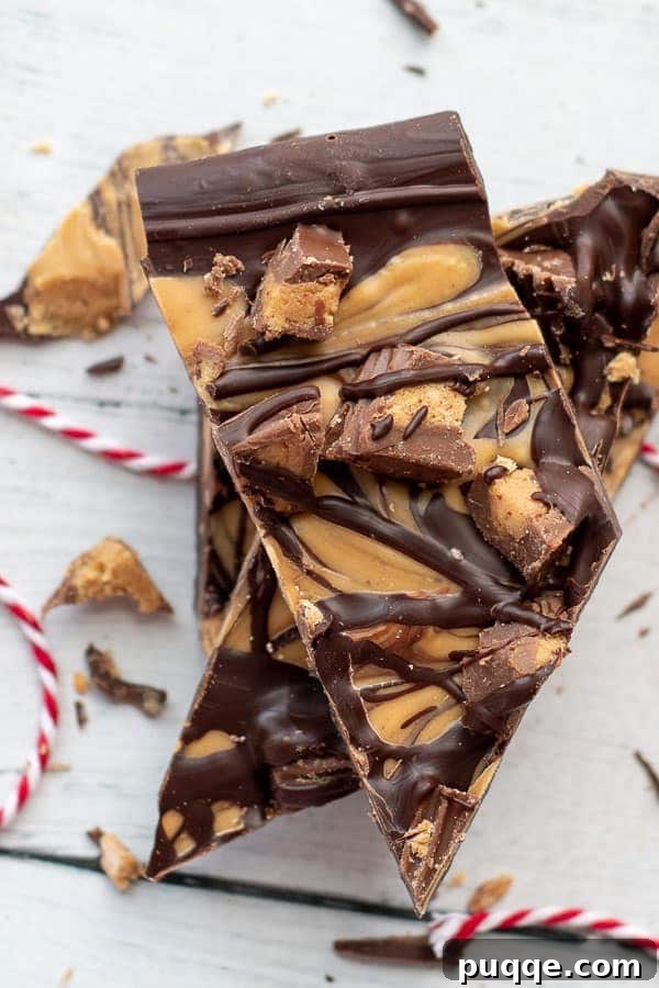 Gluten-Free 3-Ingredient Chocolate Peanut Butter Bark 2 An overhead shot of glossy Tiger Butter chocolate peanut butter candy stacked up, showcasing its swirl pattern and peanut butter cup pieces.
