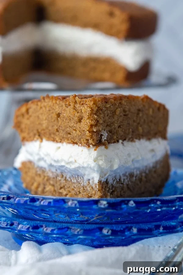 Dreamy Homemade Oatmeal Creme Pie Cake 2 A beautifully sliced homemade oatmeal creme pie cake on a blue plate, ready to be enjoyed.