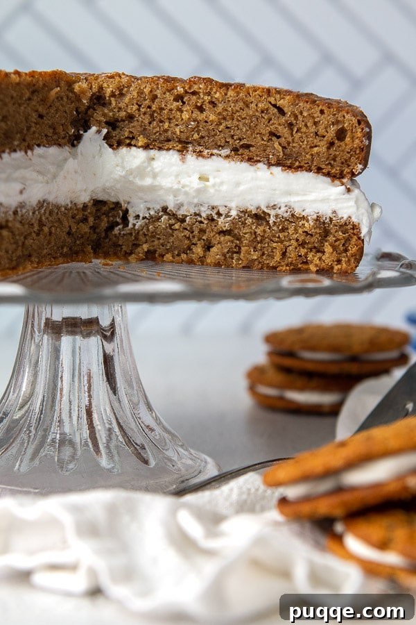 Dreamy Homemade Oatmeal Creme Pie Cake 6 A giant homemade oatmeal creme pie cake on a cake stand, surrounded by classic Little Debbie snack cakes for comparison.