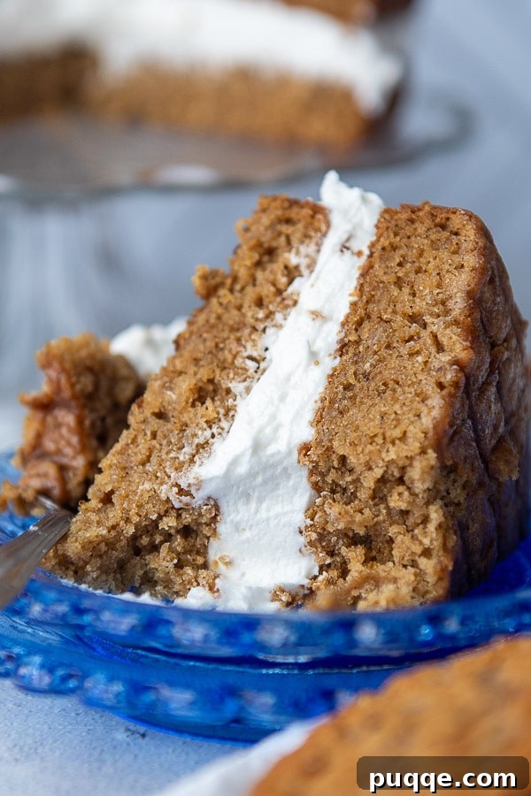 Dreamy Homemade Oatmeal Creme Pie Cake 7 A tempting slice of oatmeal cream pie cake on a blue plate, with a small bite taken out, highlighting its fluffy filling.