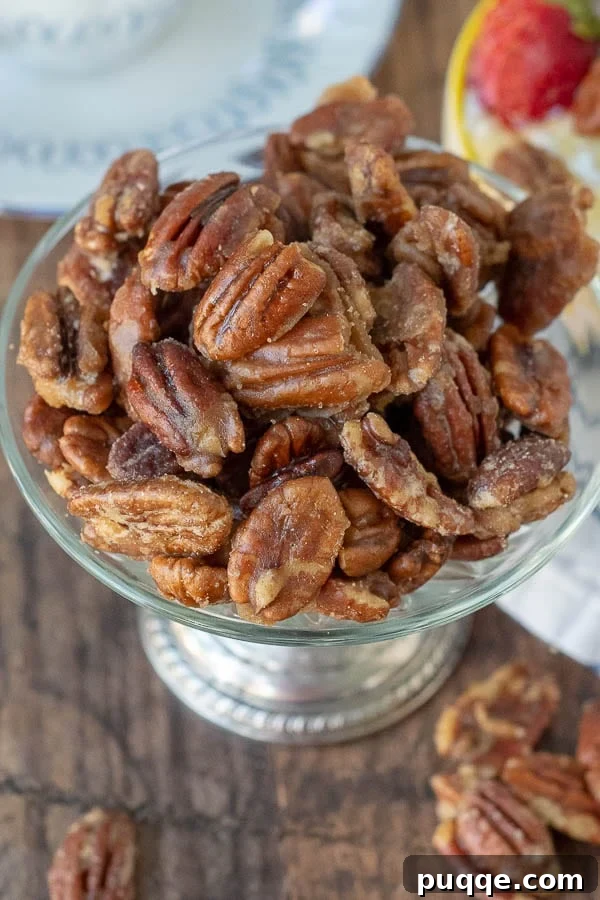 Effortless 5-Minute Candied Pecans 2 An overhead shot of glossy, golden candied pecans in an antique silver bowl, ready to be enjoyed.