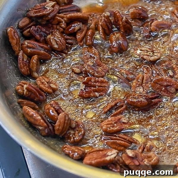 Effortless 5-Minute Candied Pecans 4 The second step in creating candied pecans, illustrating pecans being stirred into the simmering maple and brown sugar syrup.