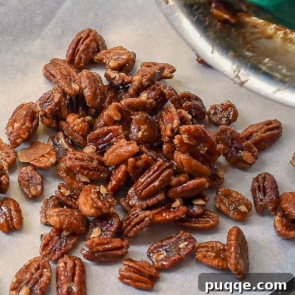 Effortless 5-Minute Candied Pecans 6 The fourth and final step, showing candied pecans freshly poured onto a prepared baking sheet, cooling and ready to harden.