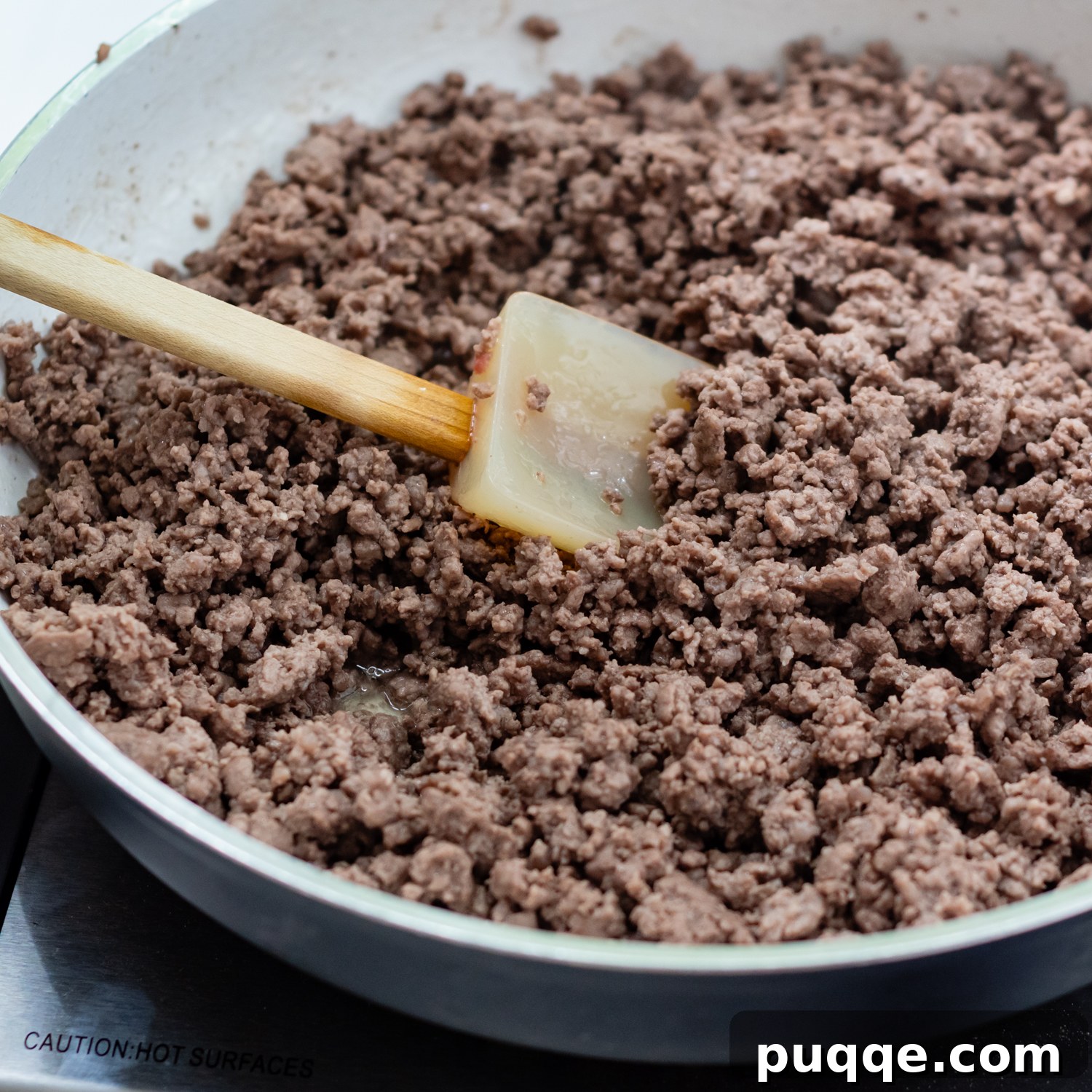 Browned ground beef in a skillet, ready for the next step