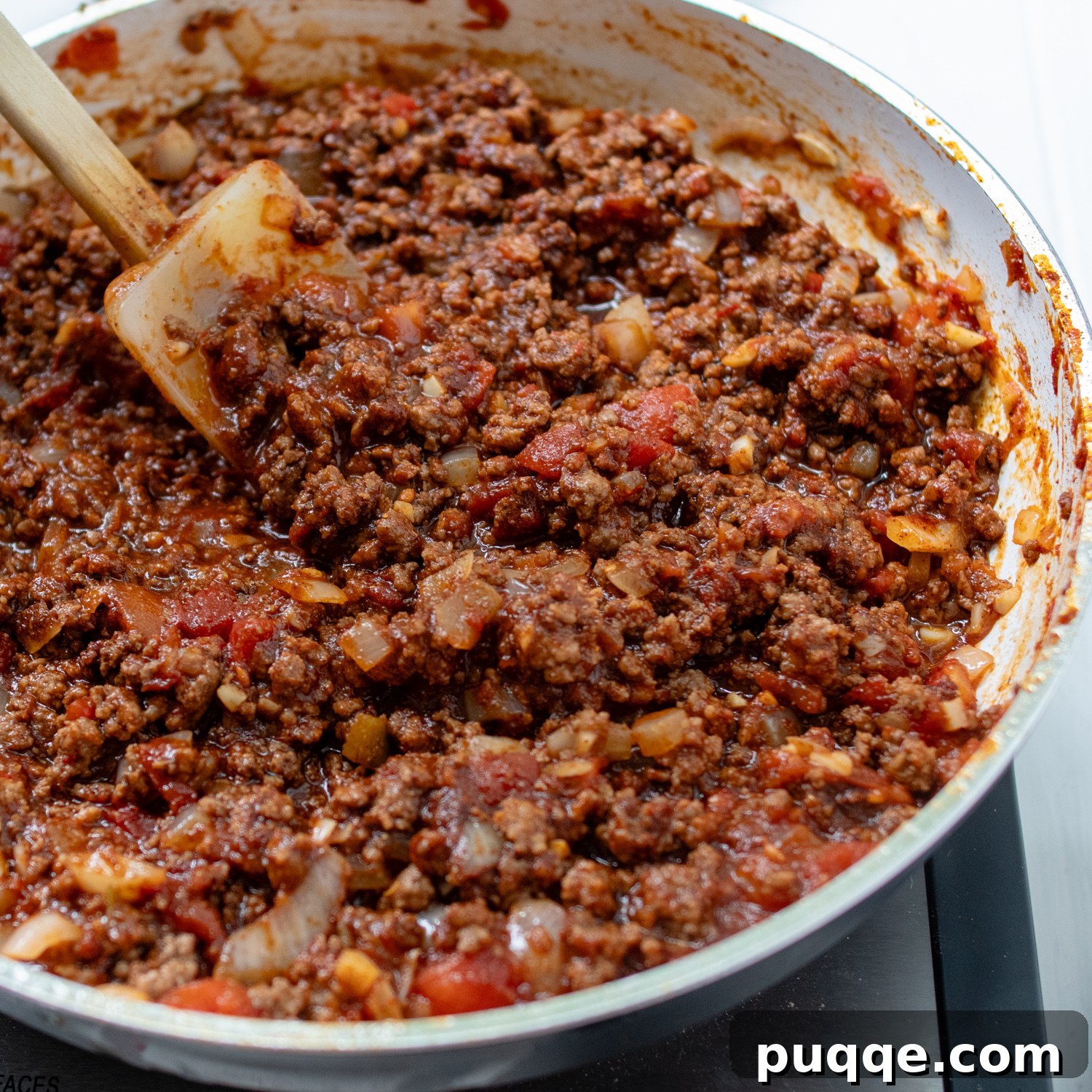 The seasoned taco meat in a skillet, mixed with a rich sloppy joe-style sauce